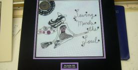 The embroidery shown here is matted with a plaque for the description/title.