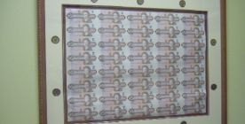 The framing of a 2 Dollar Bill sheet and 2 Dollar coins around it using a double mat.