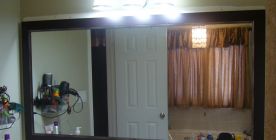 Custom framed mirror and professionally hung.